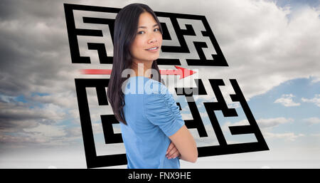 Composite image of smiling asian woman with arms crossed looking over her shoulder Stock Photo