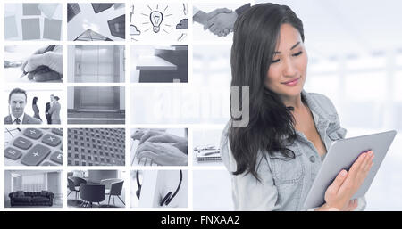 Composite image of asian woman holding tablet Stock Photo