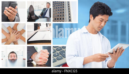 Composite image of male looking at his tablet computer Stock Photo