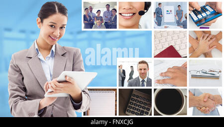 Composite image of portrait of a smiling businesswoman using a tablet computer Stock Photo