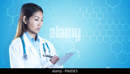 Composite image of asian doctor writing on files Stock Photo