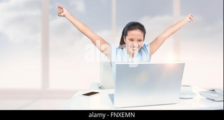 Composite image of celebrating woman with arms raised Stock Photo