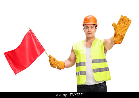Construction worker waving a red flag and making a stop hand gesture isolated on white background Stock Photo