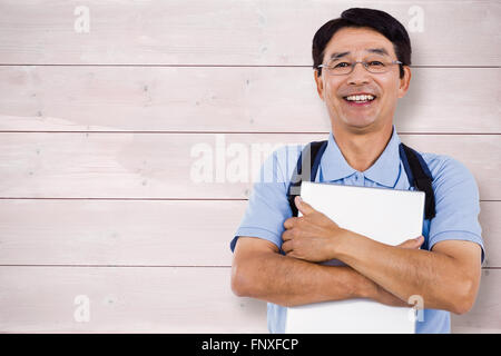 Composite image of portrait of cheerful man holding documents Stock Photo