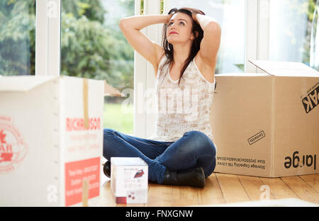 Woman moving house Stock Photo