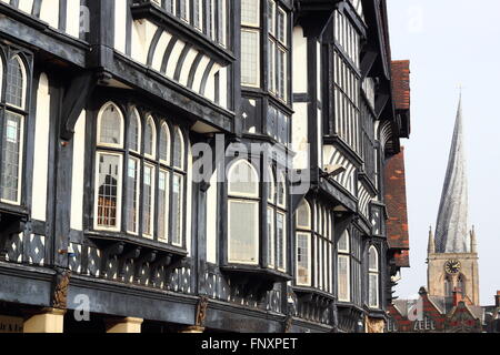 Black and white buildings on Knifesmithgate in Chesterfield town centre looking to twisted spire of St Mary and All Saint UK Stock Photo