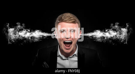 Angry man with smoke coming out from his ears. Stock Photo