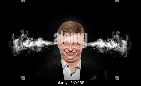 Stressful man with smoke coming out from his ears. Stock Photo