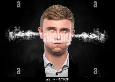 Stressful man with smoke coming out from his ears. Stock Photo