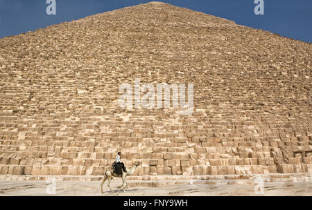 CAIRO, EGYPT - JULY 20: The Giza Necropolis with a tourism police riding a camel by the archaeological site , On July 20, 2010 C Stock Photo