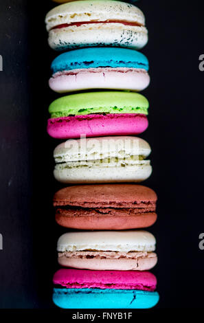 Stack of macaroons biscuits over black background Stock Photo