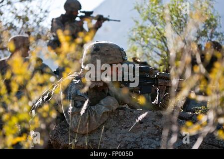 U.S. Army infantry soldiers watch a ridge line for Taliban activity during an operation November 9, 2010 in the Shal Valley, Nuristan Province, Afghanistan. Stock Photo