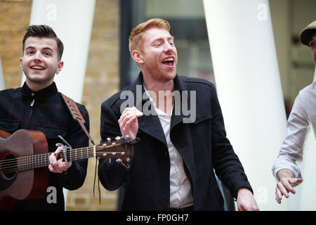 London, UK. 16th March, 2016. CC Smugglers performs at the launch. Morning commuters are treated to a unique variety show by Buskers and street performers during rush hour at King's Cross Station at the world's first ever International Busking day is announced by the Mayor of London. Stock Photo