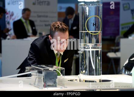 Husum, Germany. 17th Mar, 2016. Developer Benedikt Sinner looking at a facility for producing hydrogen at the stand of H-Tec Systems at the 'New Energy Husum' fair in Husum, Germany, 17 March 2016. Roughly 150 exhibitors inform about climate friendly renewable energy for the production of electricity, high and low temperatures as well as fuel. The organisers expect about 10,000 visitors from Germany and other countries. PHOTO: CARSTEN REHDER/dpa/Alamy Live News Stock Photo