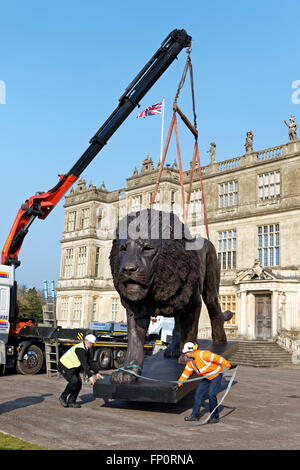 Longleat House, Wiltshire, UK. 17th March, 2016. A magnificent sculpture of a lion by African based sculptor Bruce Little which was commissioned by Ceawlin Thynn, Viscount Weymouth of Longleat, was today unveiled in front of Longleat House in Wiltshire as part of the 50th anniversary celebrations at Longleat. The 8m long by 4.3m tall statue has been sculpted in bronze in Africa. Credit:  Andrew Harker/Alamy Live News Stock Photo