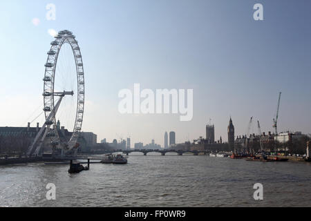 Westminster, London, UK. 17th March 2016. Clear skies and hazy sunshine over the London Eye and the River Thames. Credit:  Julia Gavin UK/Alamy Live News Stock Photo