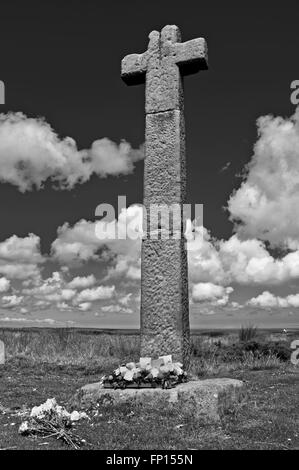 Floral tributes left at the base of Young Ralph Cross, by the Westerdale road junction on Blakey Ridge, North York Moors Stock Photo