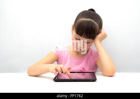 Little girl using a tablet pc Stock Photo