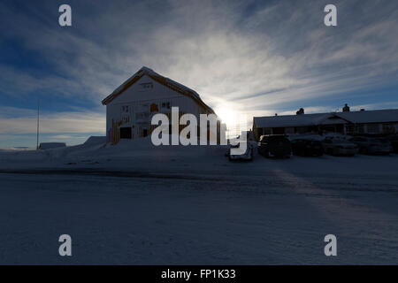 Dyranut Mountain Lodge, the highest on road R7, in Hardangervidda, buried in snow during the winter season. Stock Photo