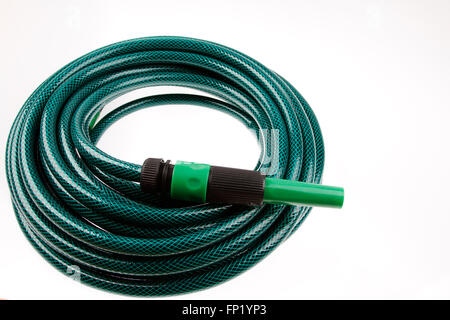 Garden hose coiled on plain background Stock Photo