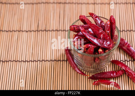 Red Chillis (close-up shot, selective focus) on wooden background Stock Photo