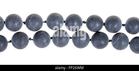 two strings of beads from gray Shungite gem stone isolated on white background Stock Photo