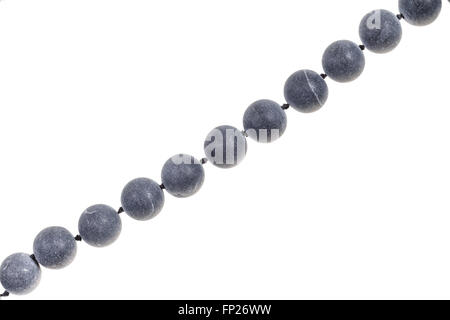 string of beads from gray Shungite gem stone isolated on white background Stock Photo