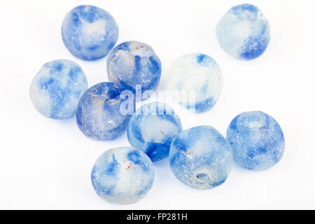 several beads from rough blue painted glass on white background Stock Photo