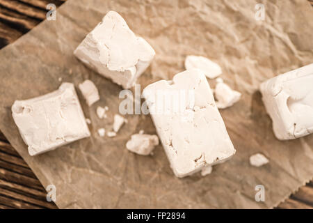 Block of Yeast (selective focus) on wooden background Stock Photo