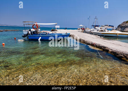 Old traditional beautiful fishing boats by the sea in Rhodes island in Greece Stock Photo