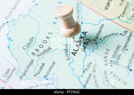 push pin marking Alaska on a world map as a destination concept Stock Photo