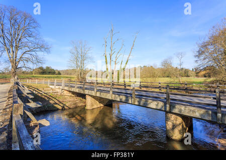 Tilford West Bridge, a scheduled monument medieval bridge over the River Wey, in the village of Tilford near Farnham, Surrey, UK Stock Photo