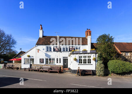 The Barley Mow, a traditional whitewashed country pub on Tilford Green in Tilford, a small village near Farnham, Surrey, UK Stock Photo