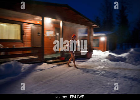 People take a sauna in a cottage next to the Kemi river, Salla, Lapland, Finland. Breath taking sauna experience. A Finnish Saun Stock Photo