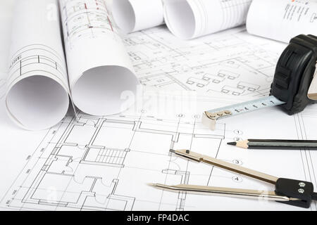 Architecture plan and rolls of blueprints with meter and calculator ...