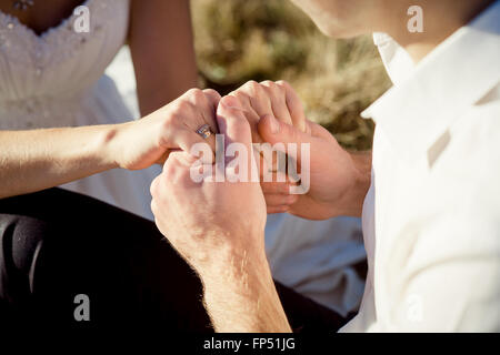 Bride and groom softly holding hands close up. Honeymoon Stock Photo