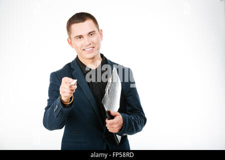 Smiling businessman holding clipboard and pointing at camera isolated on a white background Stock Photo