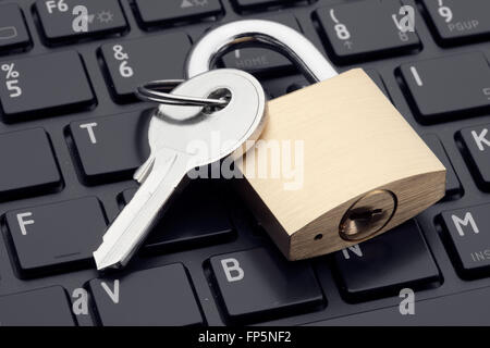 Computer security or safety concept. Laptop keyboard with lock and key Stock Photo