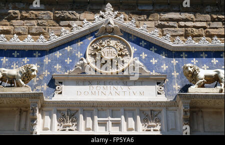 Medallion with the IHS monogram between two lions, entrance to Palazzo Vecchio in Florence, Italy Stock Photo