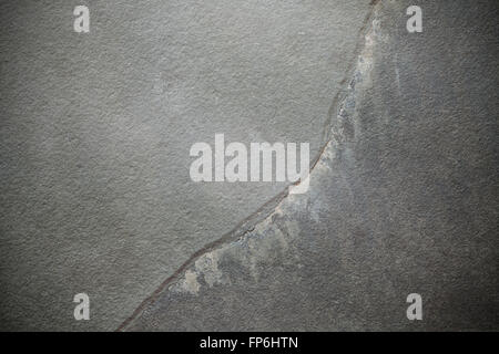 Cracked dark slate, stone background. Stock Photo