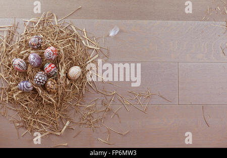 Easter eggs in nest on wooden background (space for text) Stock Photo