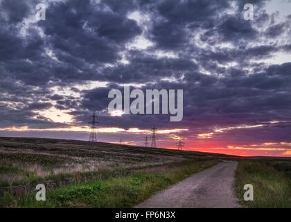 Sunset on the moors with pylons Stock Photo