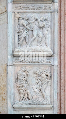 Expulsion from Paradise up, the work of Adam and Eve down, panel on the central door of San Petronio Basilica in Bologna, Italy Stock Photo