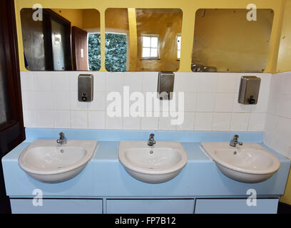 Three wash basins in a public lavatory. Stock Photo