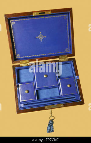 Open wooden jewelry box isolated on yellow. Vertical Stock Photo