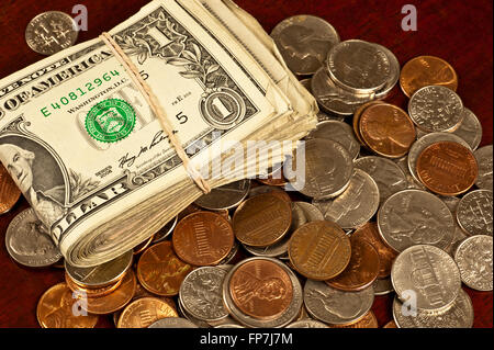 Dollar Bills and Mixed Coins Which All Show Wear Stock Photo