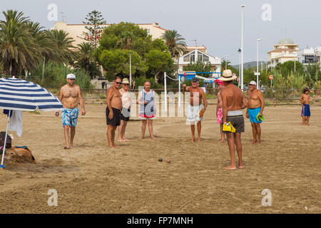 Alcossebre, Spain - 09 09, 2013: Seniors Spaniards play Bocce on sandy beach in Alcossebre, resort town in Spain Stock Photo