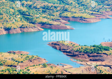 Clean blue calm water of the Krishna River near its source at Krishnabai temple, Mahabaleshwar, Maharashtra, India Stock Photo