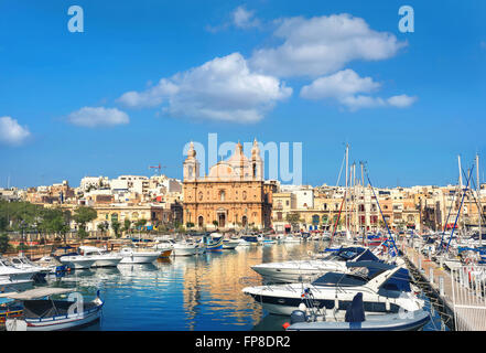 Sailing yachts at marina in front of Parish Church of St Joseph, Msida, Malta Stock Photo