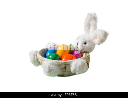 Easter Bunny with colored eggs in the basket isolated on a white background. Stock Photo